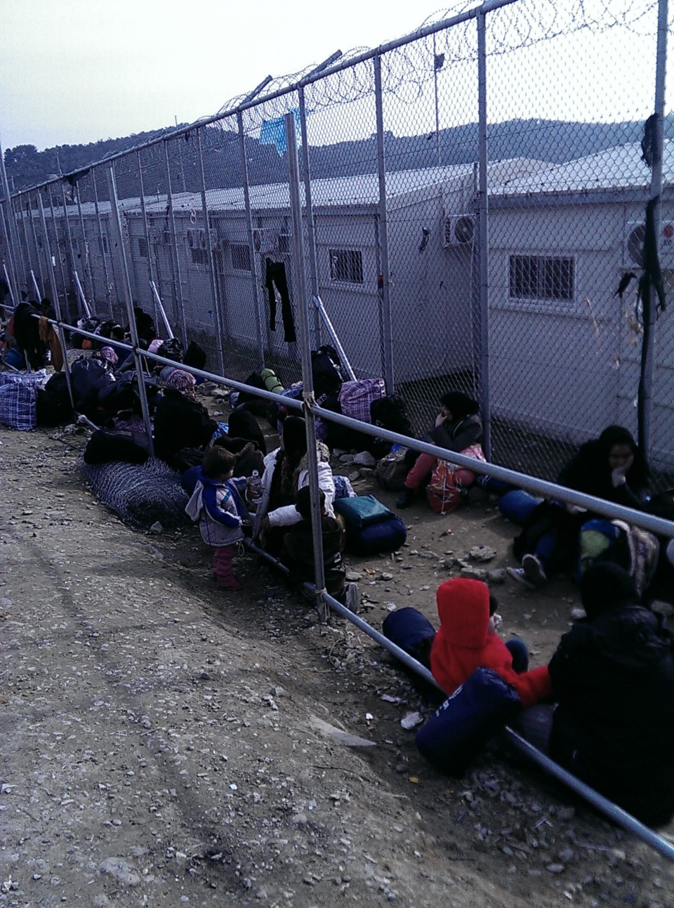 Afghan people, arrived the day before, forming a queue for the registration in Moria camp