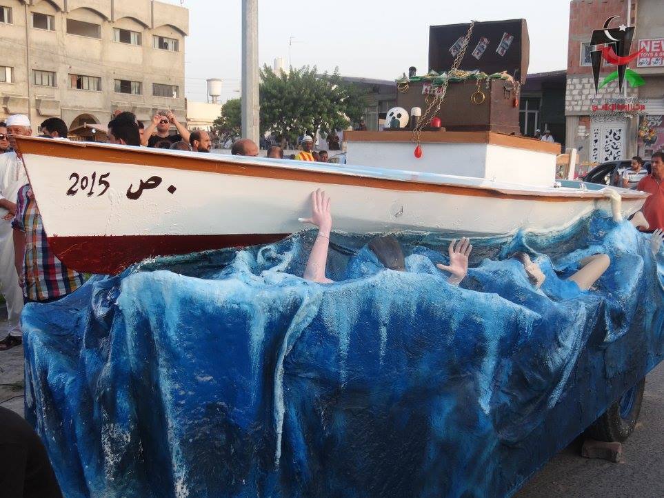 Manifestazione a Zuwara il 4 settembre 2015 contro le morti in mare e i trafficanti di uomini. Qui una piccola installazione dei manifestanti che rappresenta una barca e le persone che annegano. (Foto: Zuwara Media Center)